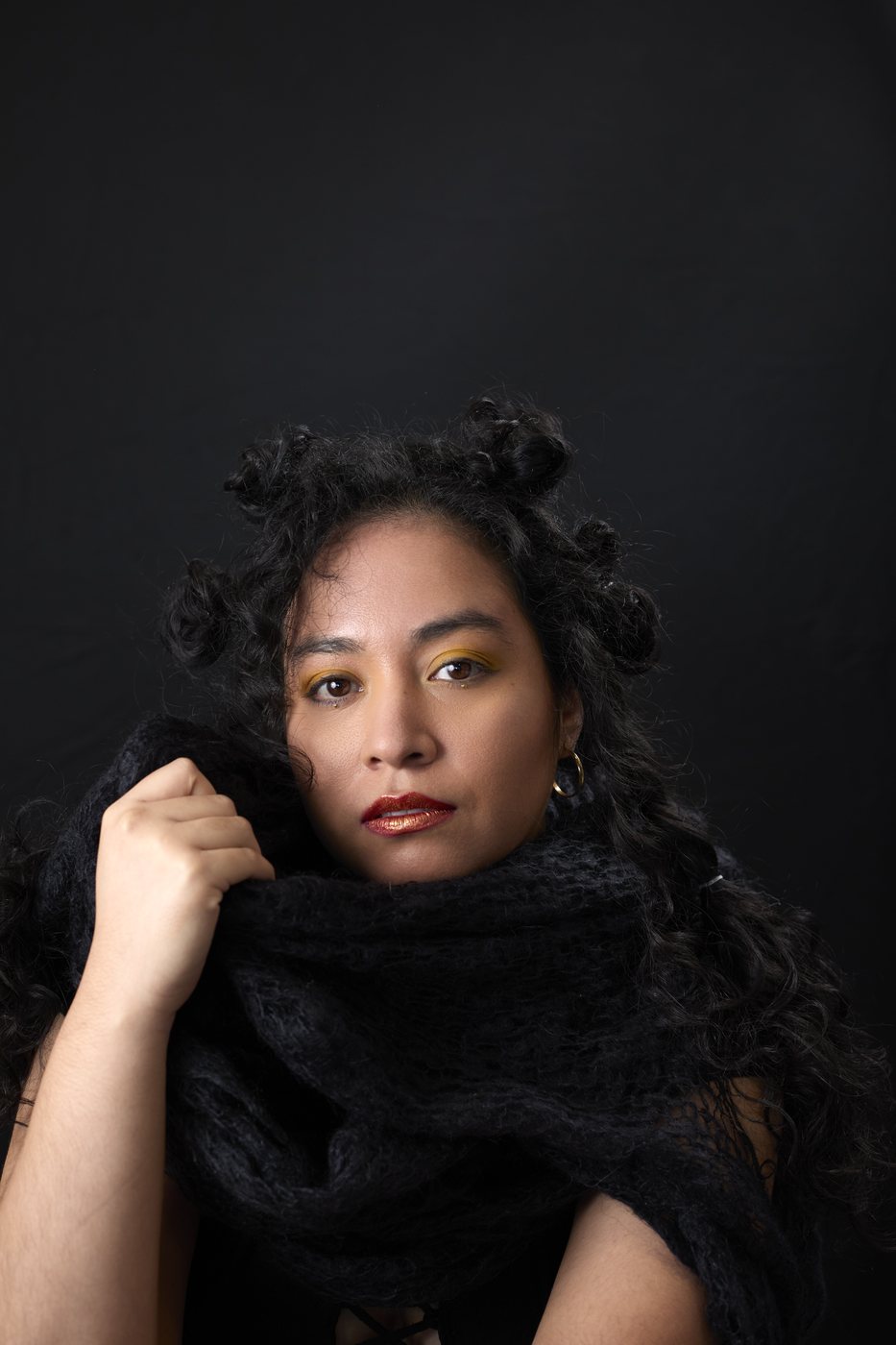 Editorial portrait with dark styling and soft light
